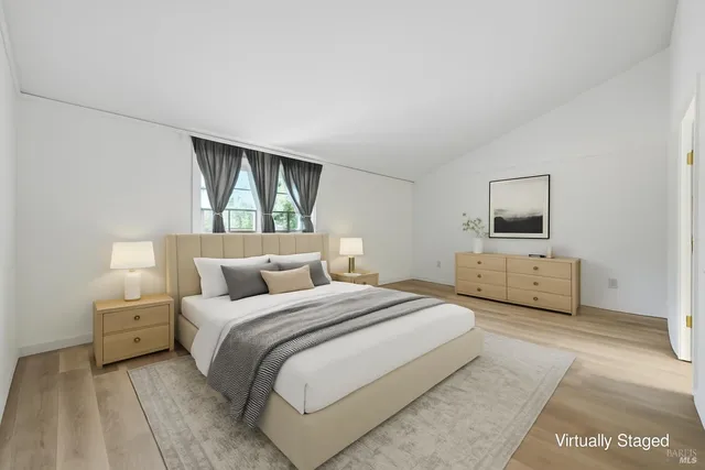 a bedroom with a bed and a television