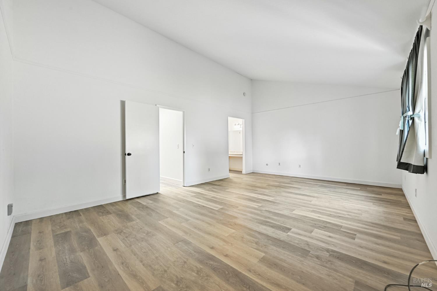 1240 North Street Santa Rosa, CA 95404 - Photo 28 of 36 a view of an empty room with wooden floor and a window