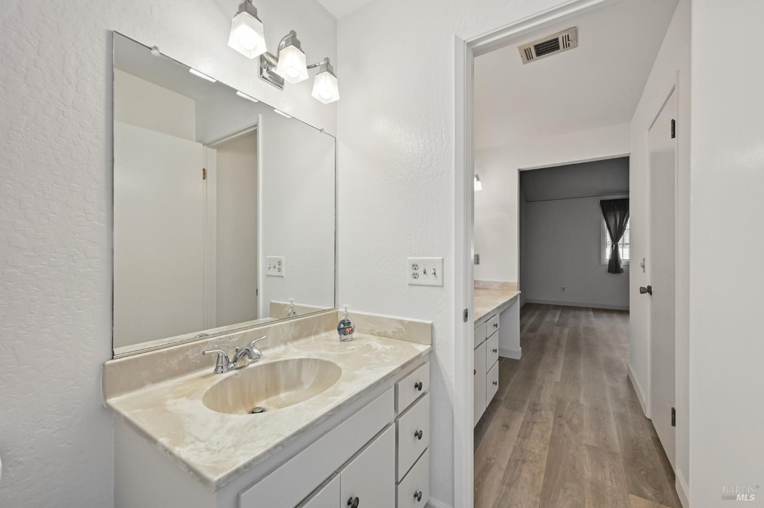 1240 North Street Santa Rosa, CA 95404 - Photo 33 of 36 a bathroom with a sink vanity granite and a mirror