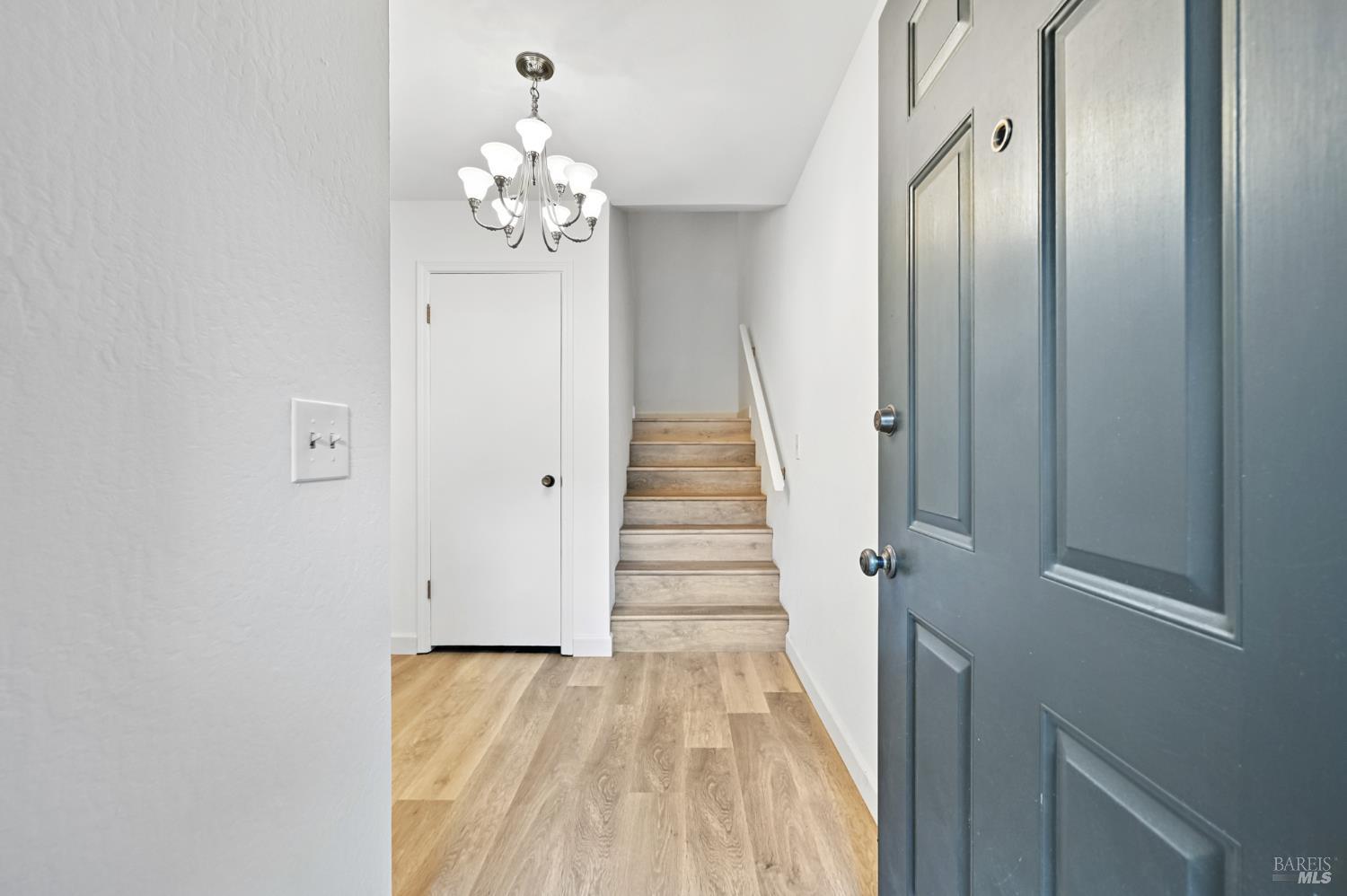 1240 North Street Santa Rosa, CA 95404 - Photo 6 of 36 a view of a hallway with wooden floor and staircase