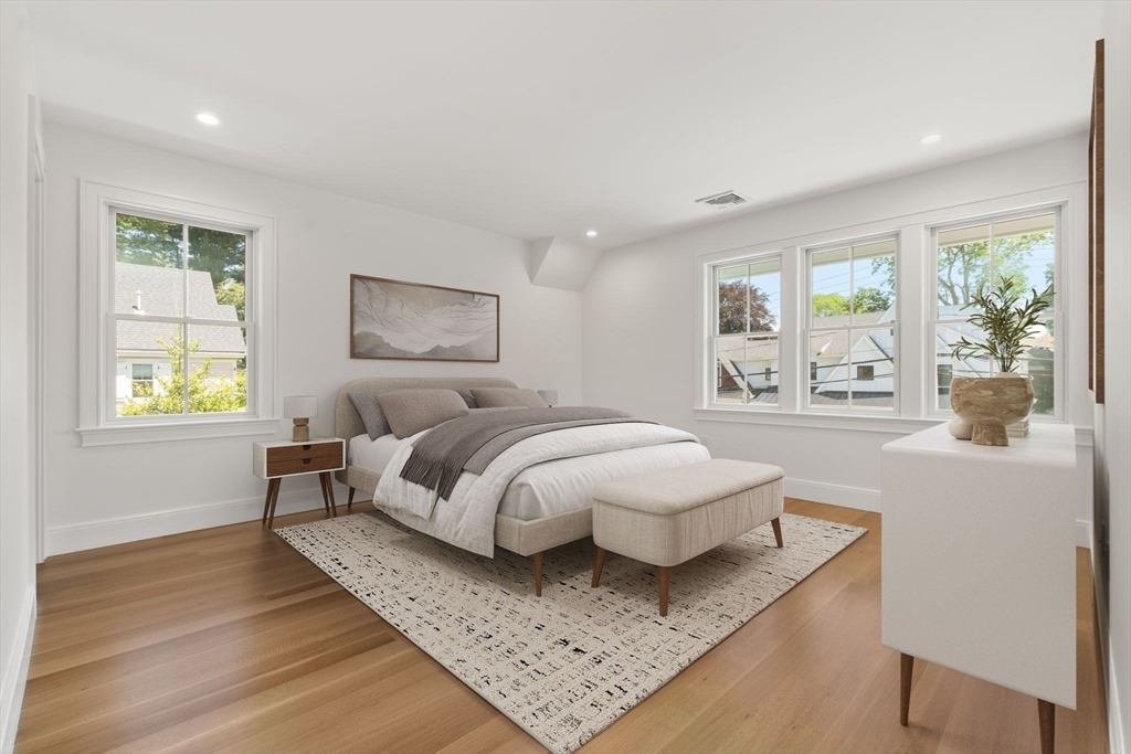 233 Warren Street Needham, MA 02492 - Photo 21 of 32 a spacious bedroom with a bed a dresser and next to a window