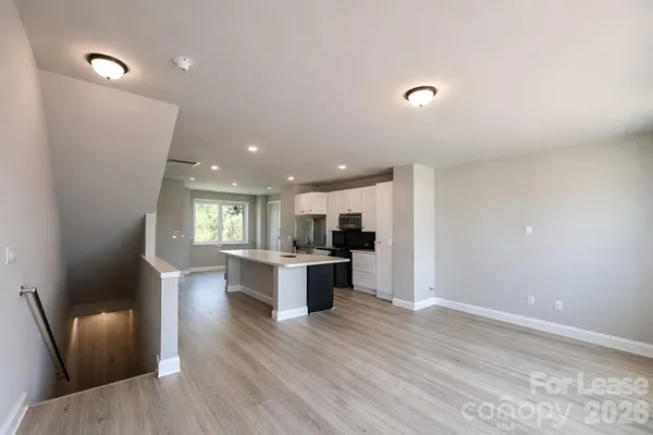 a view of kitchen with cabinets and wooden floor