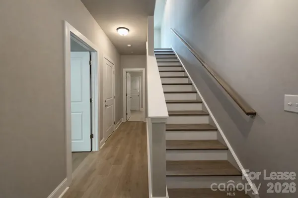 a view of entryway and hall with wooden floor