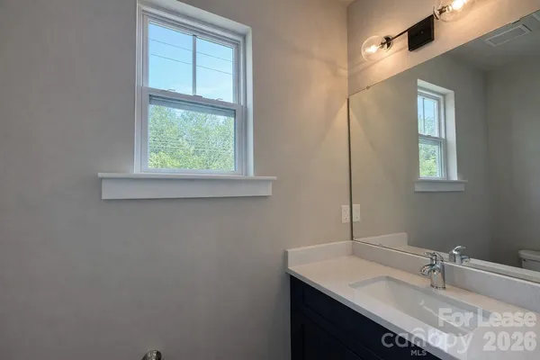 a bathroom with a sink vanity and a mirror
