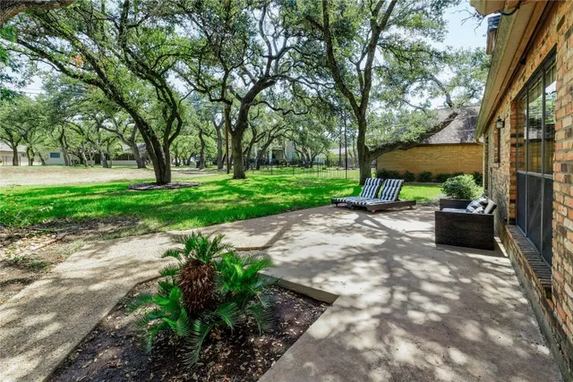 a view of a backyard with sitting area