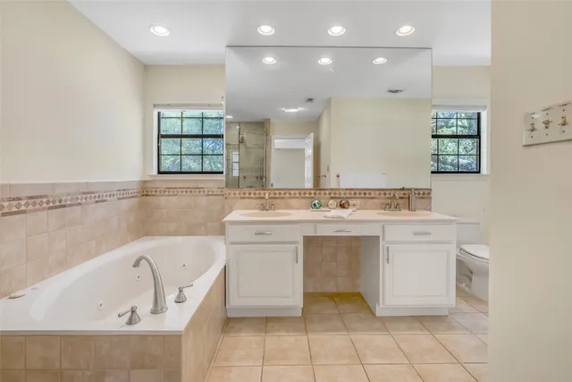 a bathroom with a sink vanity and bathtub