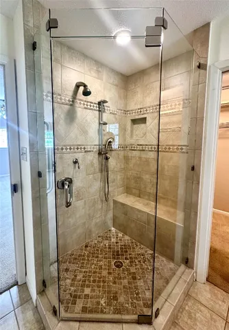 a bathroom with a shower and a sink