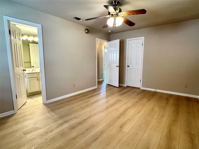 a view of an empty room and wooden floor