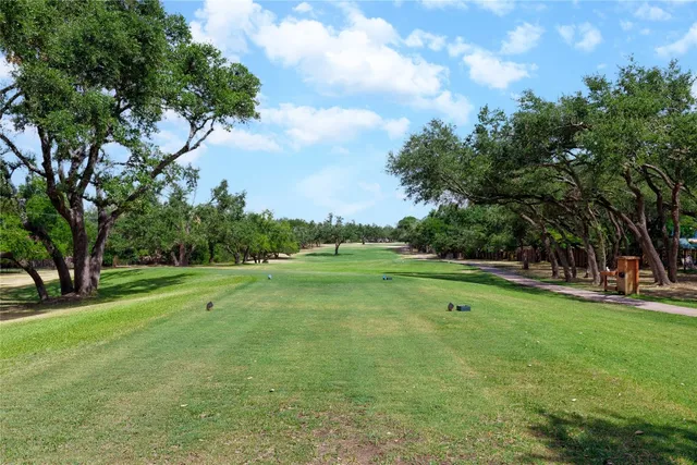 a view of field with trees in the background