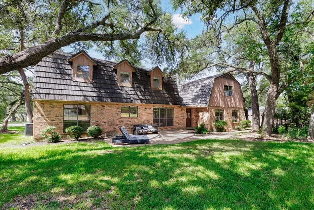 a large building with a big yard and large trees
