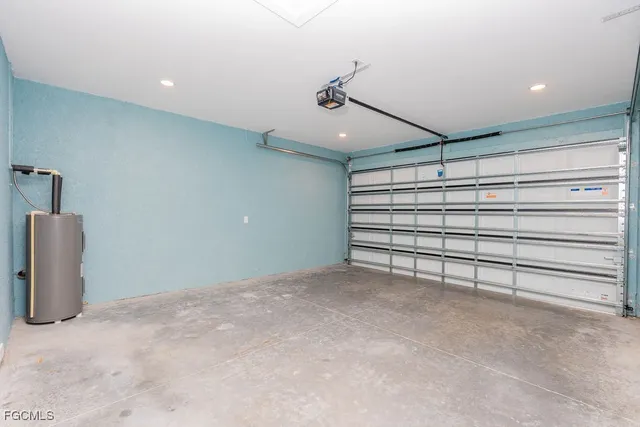 a large white kitchen with a refrigerator a kitchen island a sink and a stove