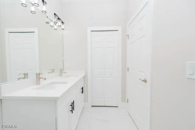 a bathroom with a sink and a mirror