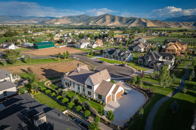 558 West Rheinfalls Circle Midway, UT 84049 - Photo 57 of 61 Elegant residence with a cream and brown exterior featuring a curved architectural entry, situated on an expansive manicured lot
