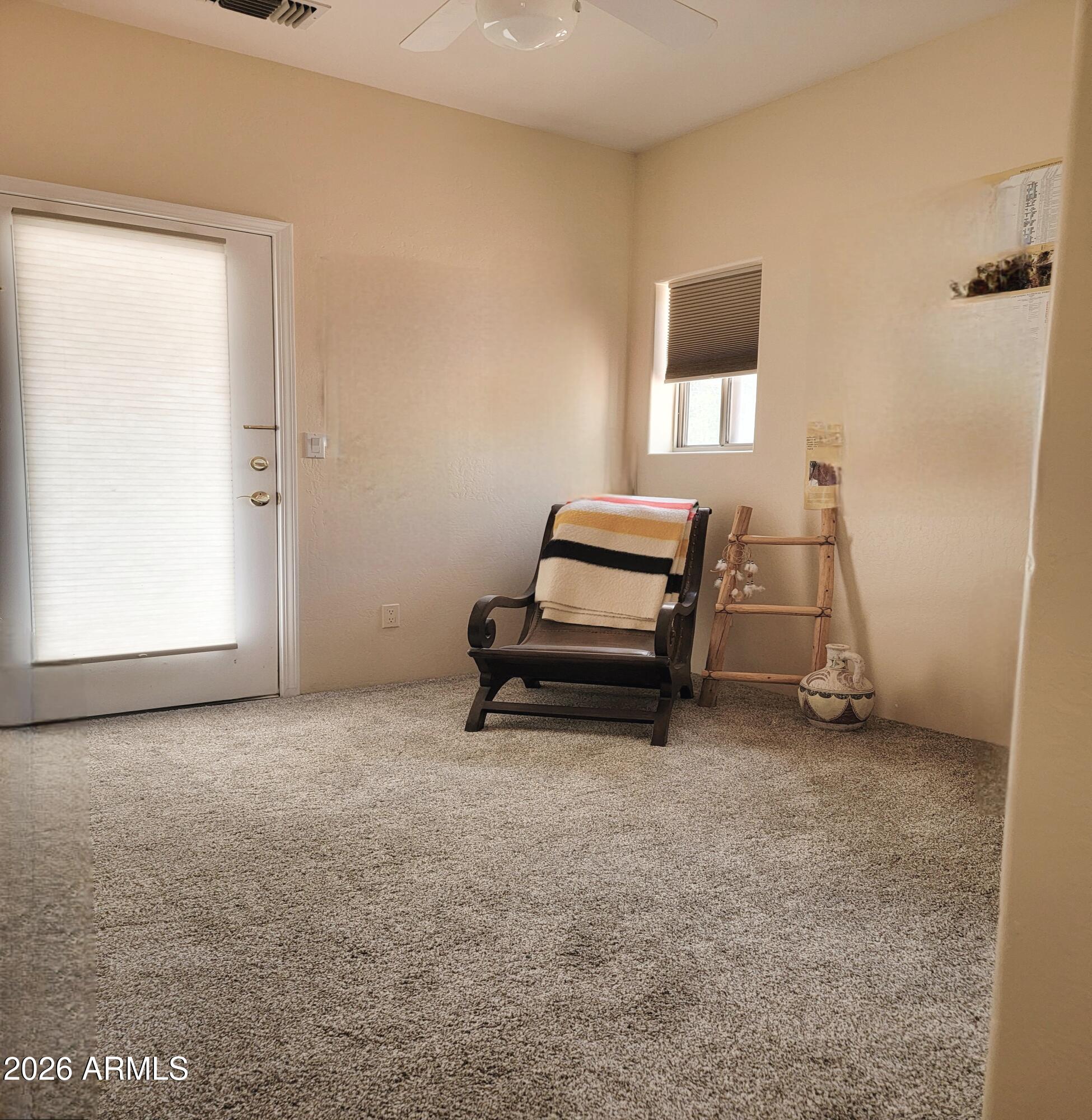 5665 North Vicki Lane Rimrock, AZ 86335 - Photo 14 of 27 a room with a chair and white walls