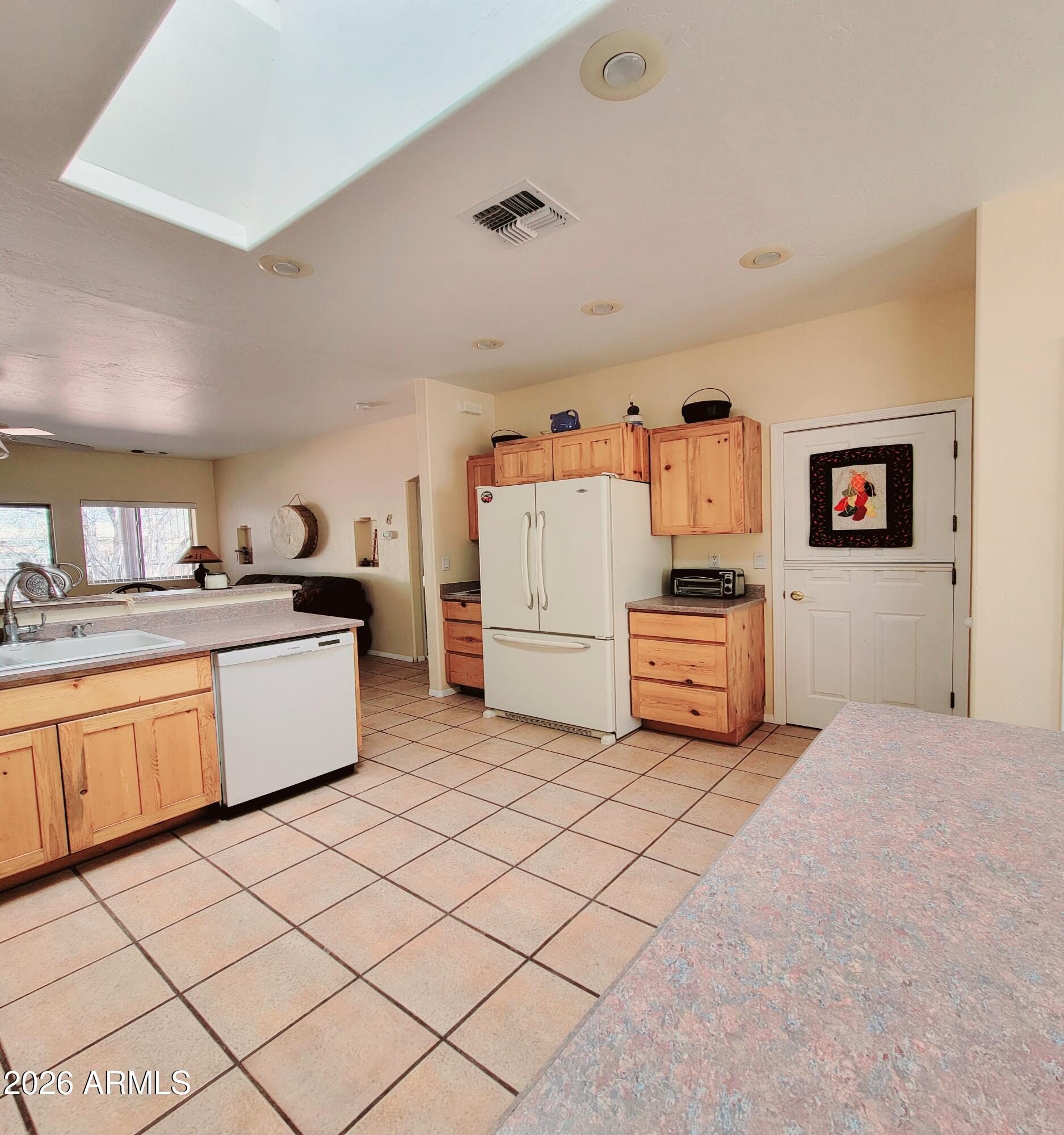 5665 North Vicki Lane Rimrock, AZ 86335 - Photo 6 of 27 a kitchen with cabinets and white appliances