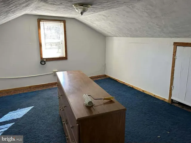 a view of a livingroom with wooden floor and a window