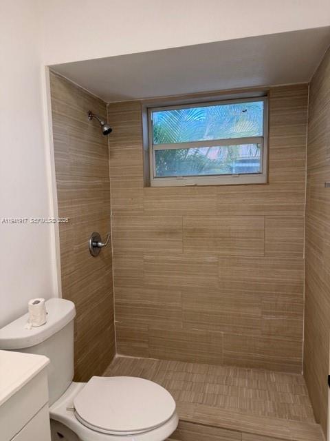 2332 Fillmore Street, Unit 612 Hollywood, FL 33020 - Photo 7 of 8 a bathroom with a toilet a sink and shower