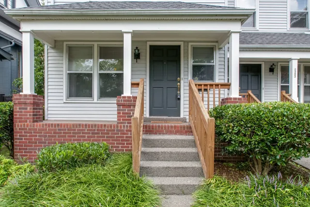 a view of a house with potted plants