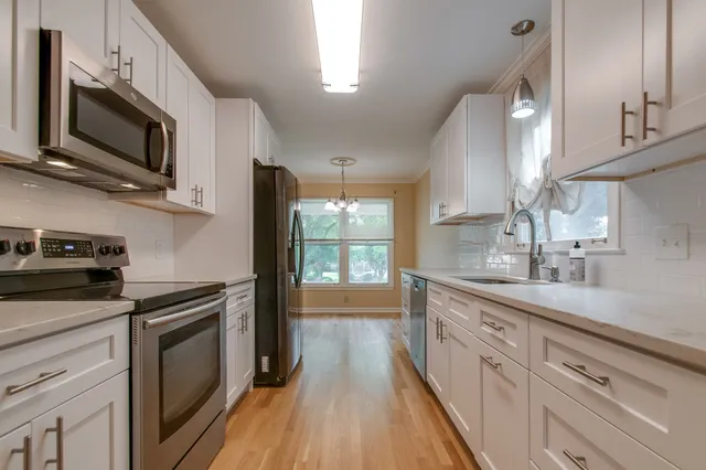 a kitchen with a sink stove and microwave