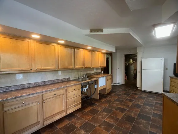 a kitchen with a sink cabinets and appliances