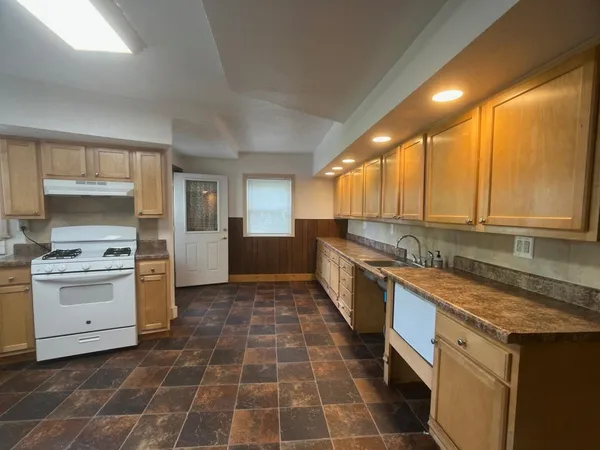 a kitchen with a stove a sink and a refrigerator
