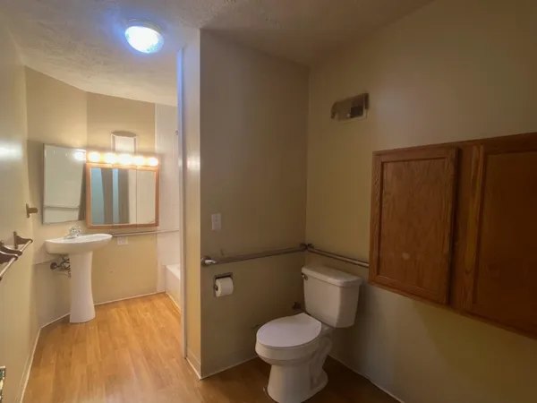 a bathroom with a sink toilet and shower