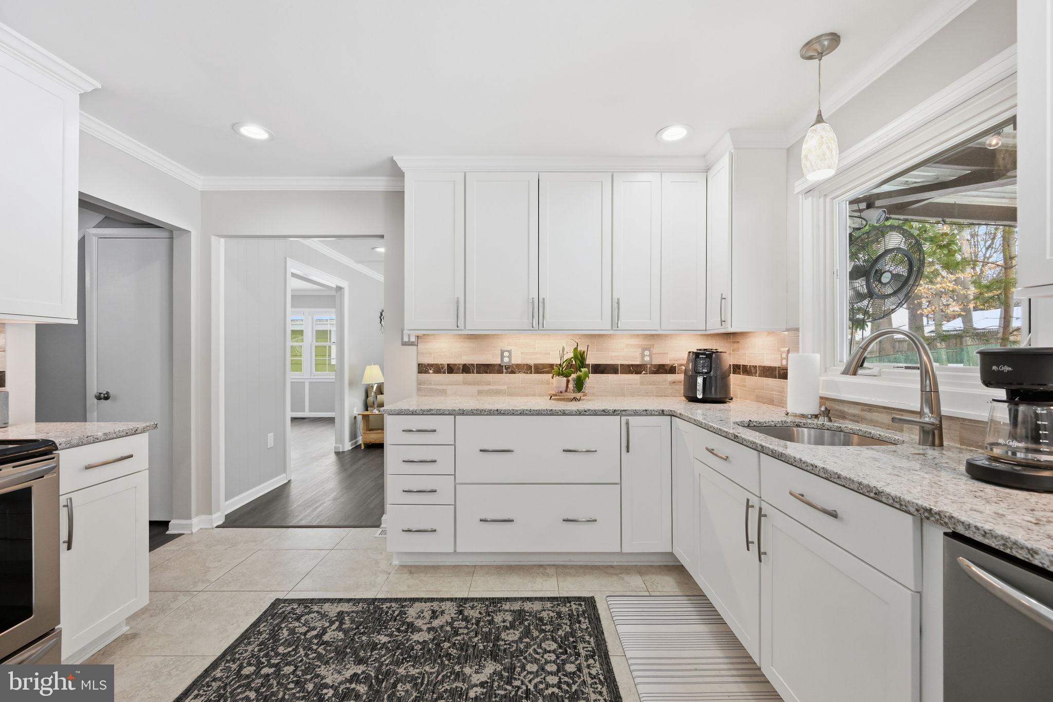 1708 Tarleton Way Crofton, MD 21114 - Photo 13 of 38 a kitchen with granite countertop white cabinets and white appliances