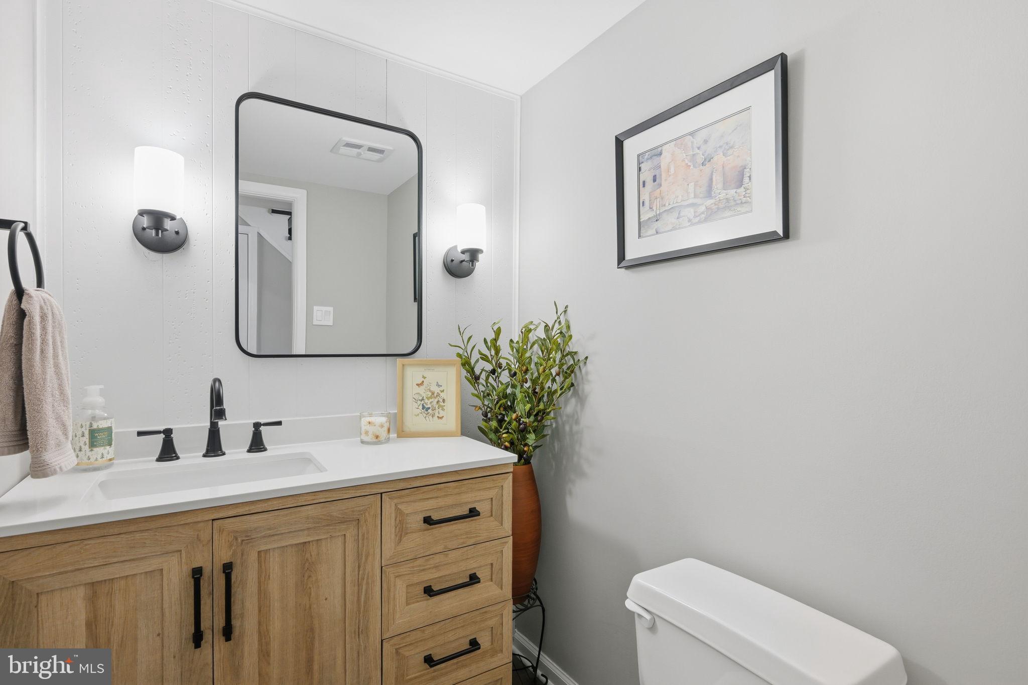 1708 Tarleton Way Crofton, MD 21114 - Photo 26 of 38 a bathroom with a toilet a sink and mirror