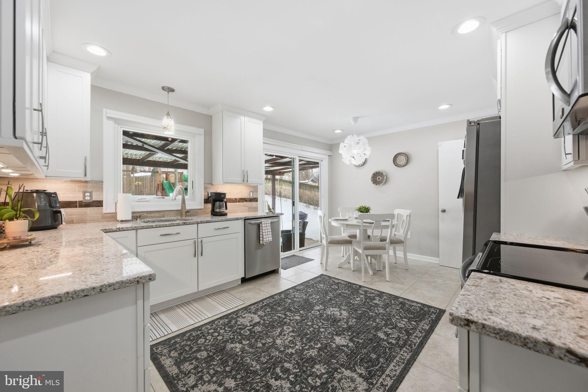 1708 Tarleton Way Crofton, MD 21114 - Photo 8 of 38 a kitchen with a sink a counter top space and stainless steel appliances