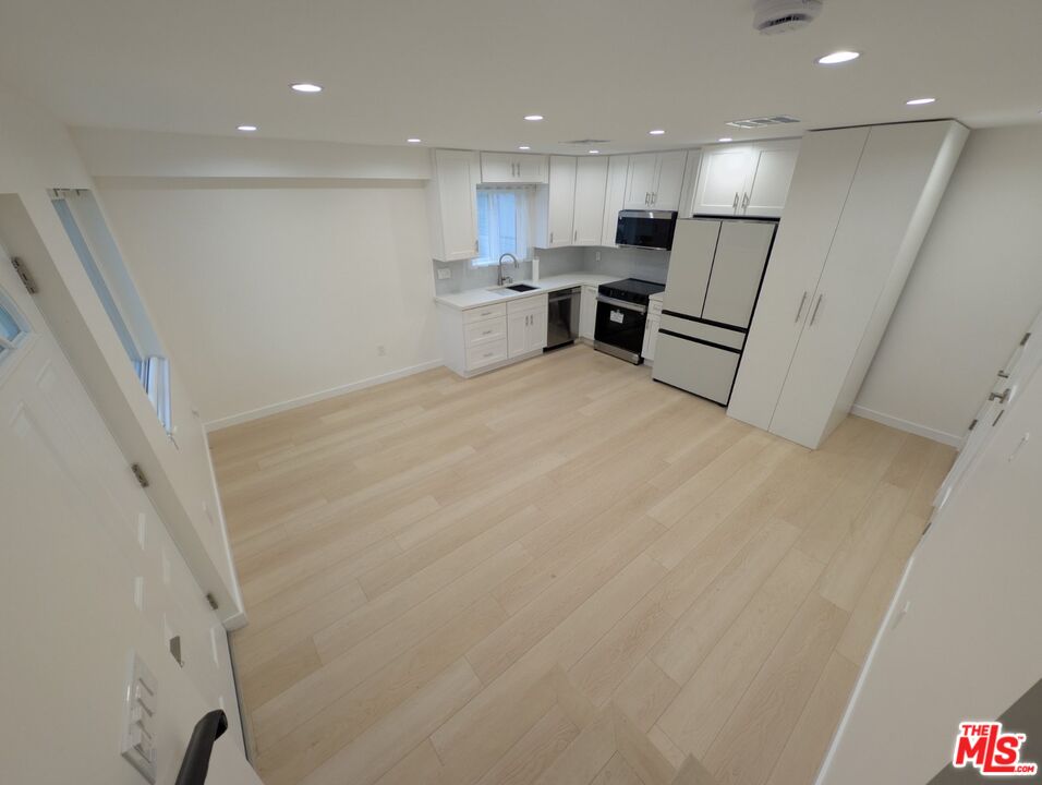 10623 Stanwin Avenue Mission Hills, CA 91345 - Photo 5 of 18 a view of kitchen with wooden floor