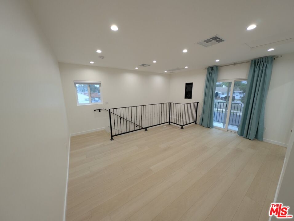 10623 Stanwin Avenue Mission Hills, CA 91345 - Photo 8 of 18 a view of a hall with a car park stairs and a ceiling fan