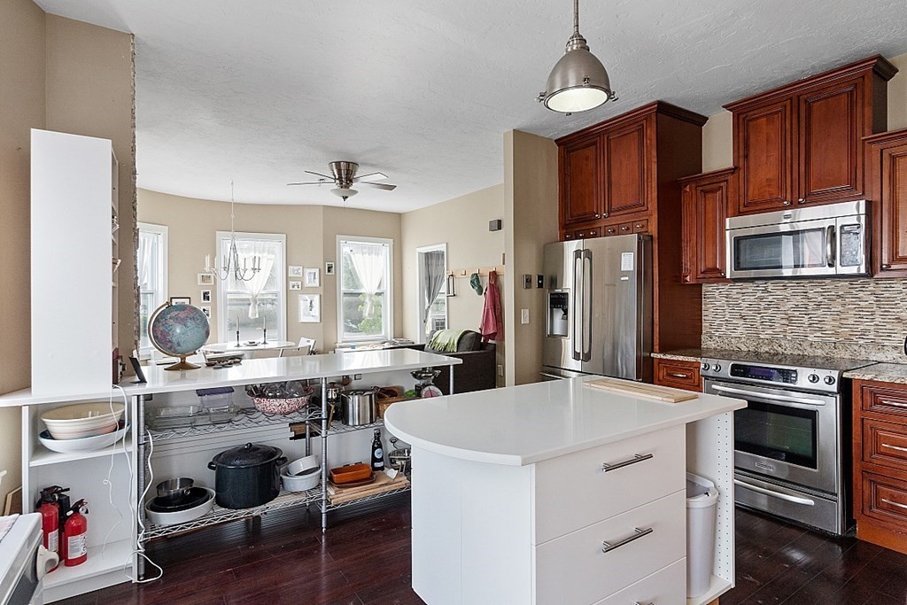 52 Providence Street, Unit 3 Worcester, MA 01604 - Photo 1 of 21 a kitchen with stainless steel appliances a stove a chimney a sink and cabinets