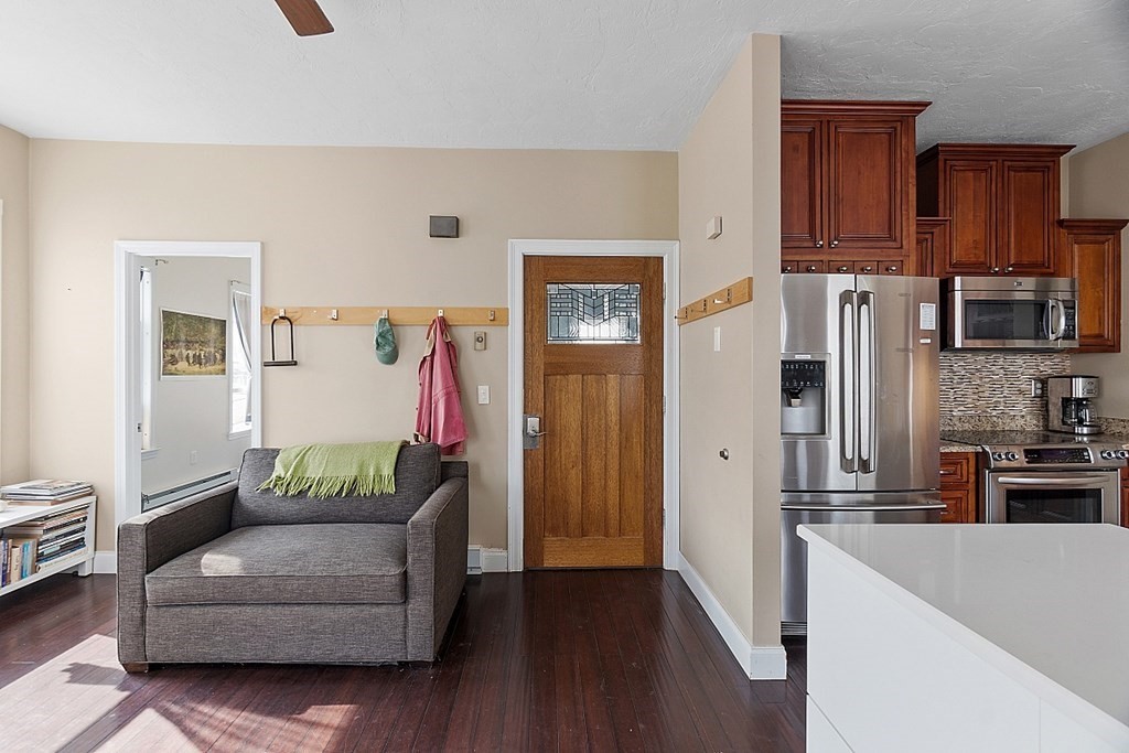 52 Providence Street, Unit 3 Worcester, MA 01604 - Photo 16 of 21 a living room with furniture and a refrigerator