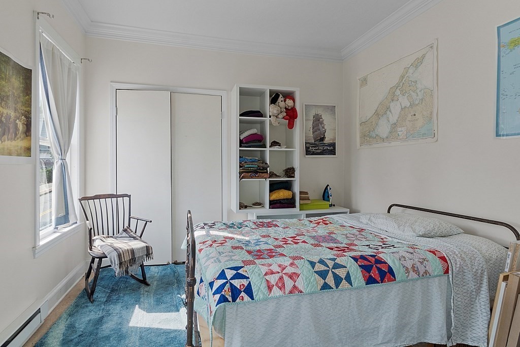 52 Providence Street, Unit 3 Worcester, MA 01604 - Photo 18 of 21 a bedroom with a bed and a window