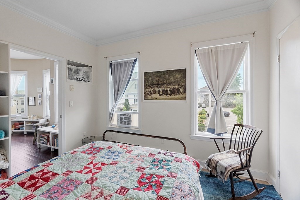 52 Providence Street, Unit 3 Worcester, MA 01604 - Photo 20 of 21 a bedroom with a bed and a chair