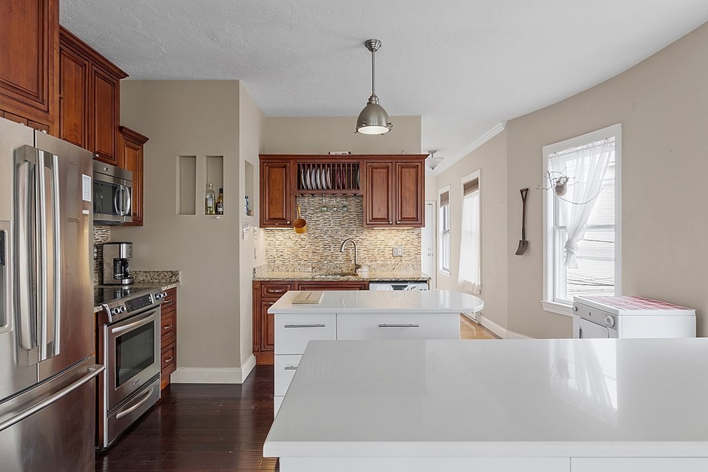 52 Providence Street, Unit 3 Worcester, MA 01604 - Photo 2 of 21 a kitchen with stainless steel appliances granite countertop a stove refrigerator and cabinets
