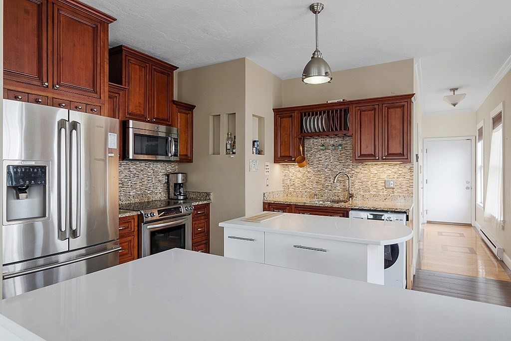 52 Providence Street, Unit 3 Worcester, MA 01604 - Photo 3 of 21 a kitchen with stainless steel appliances granite countertop a stove refrigerator sink and microwave