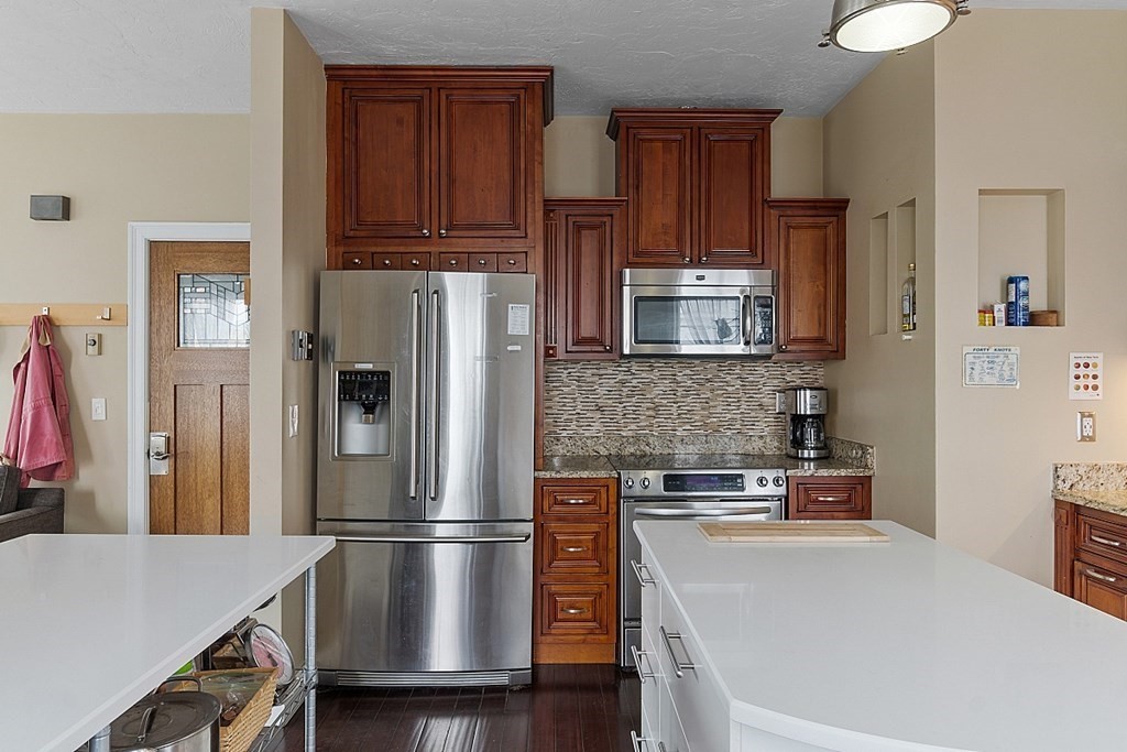 52 Providence Street, Unit 3 Worcester, MA 01604 - Photo 5 of 21 a kitchen with stainless steel appliances a refrigerator and a stove top oven