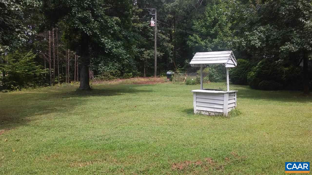 8988 Howardsville Road Howardsville, VA 24562 - Photo 8 of 12 a backyard of a house with table and chairs