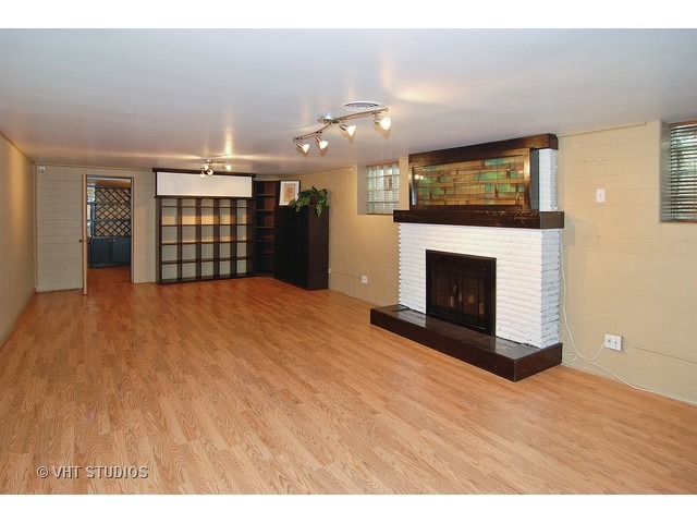 229 Blackhawk Road Riverside, IL 60546 - Photo 5 of 25 a view of empty room with kitchen and fireplace