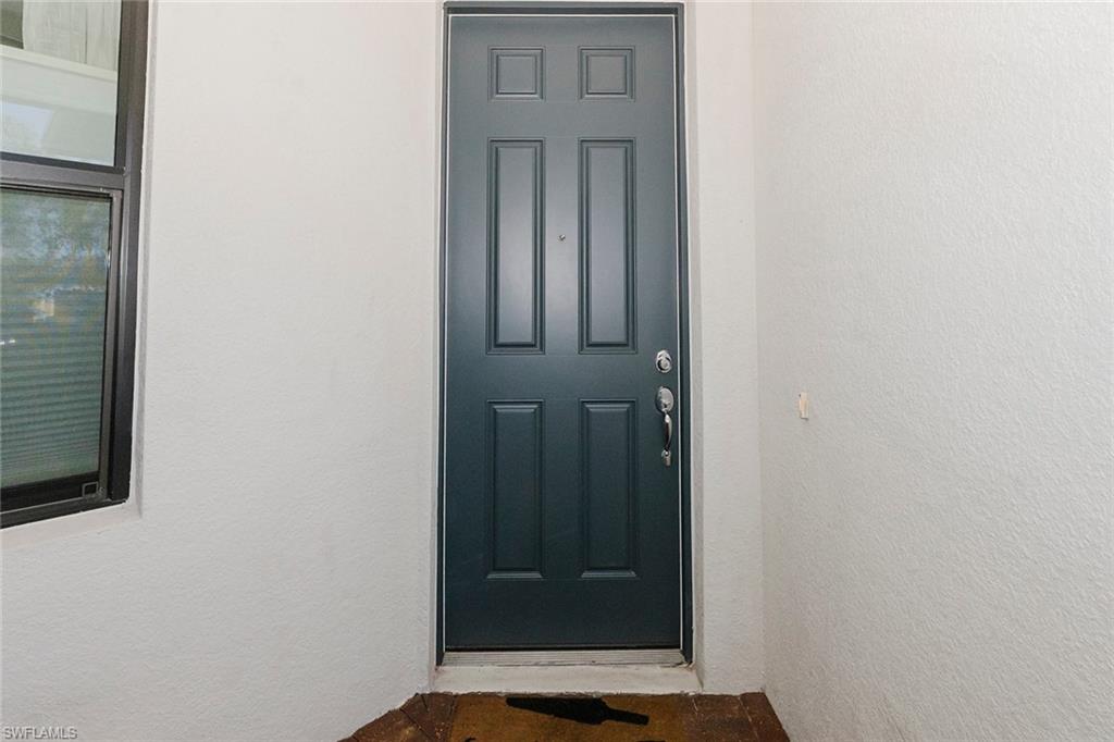 5948 Mayflower Way Ave Maria, FL 34142 - Photo 7 of 49 Front door inside screened front porch