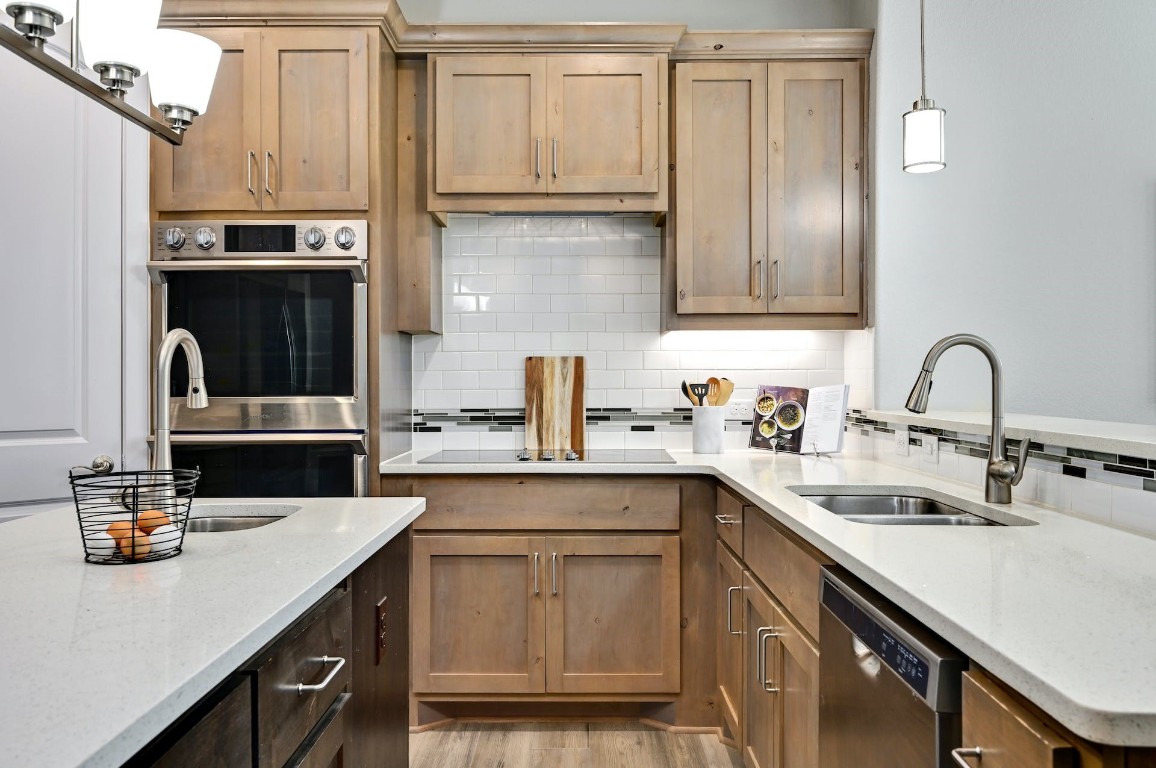 a kitchen with stainless steel appliances a sink and cabinets