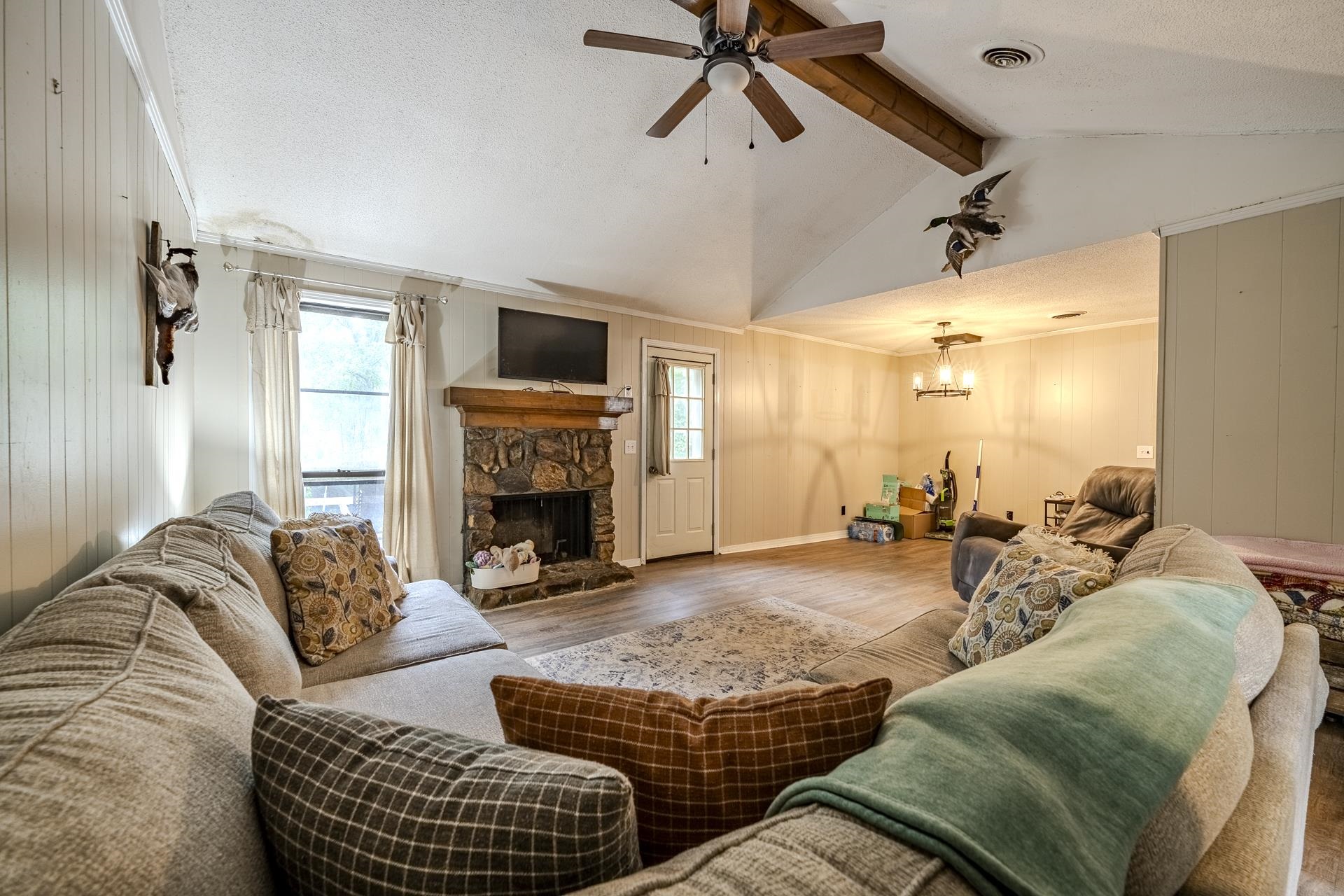 259 Oakview Drive Adamsville, TN 38310 - Photo 7 of 32 Living area featuring a vaulted ceiling with exposed wood beams, a ceiling fan, and wood-finish flooring