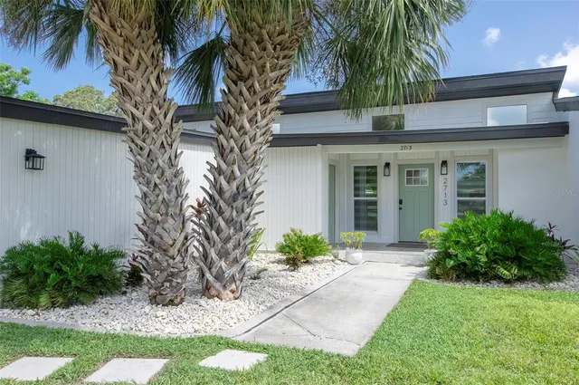 a front view of a house with a garden