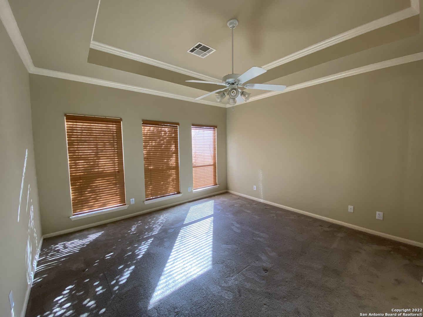 15518 Portales Pass Helotes, TX 78023 - Photo 12 of 25 en empty room with windows and ceiling fan