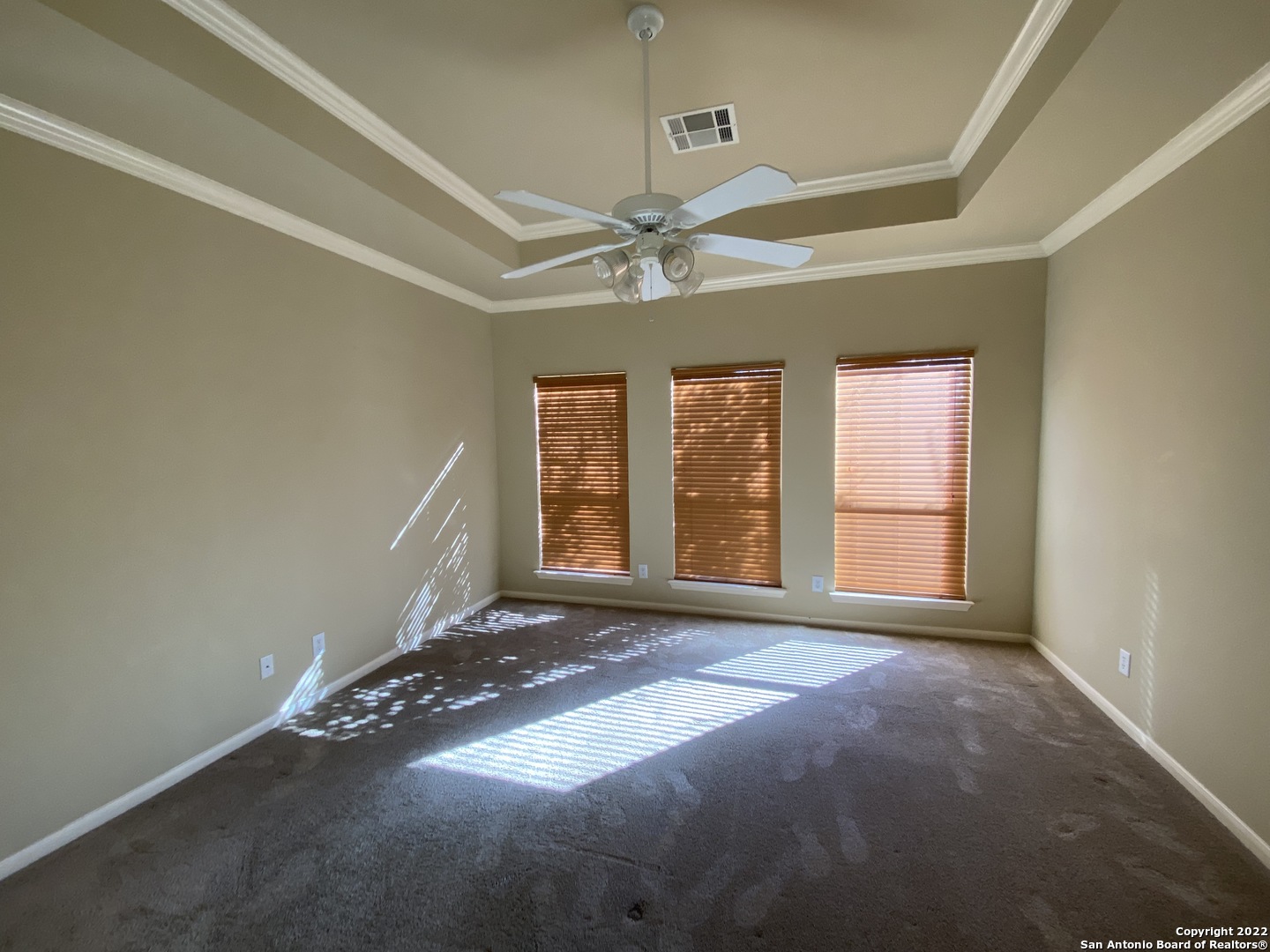 15518 Portales Pass Helotes, TX 78023 - Photo 13 of 25 an empty room with windows and ceiling fan