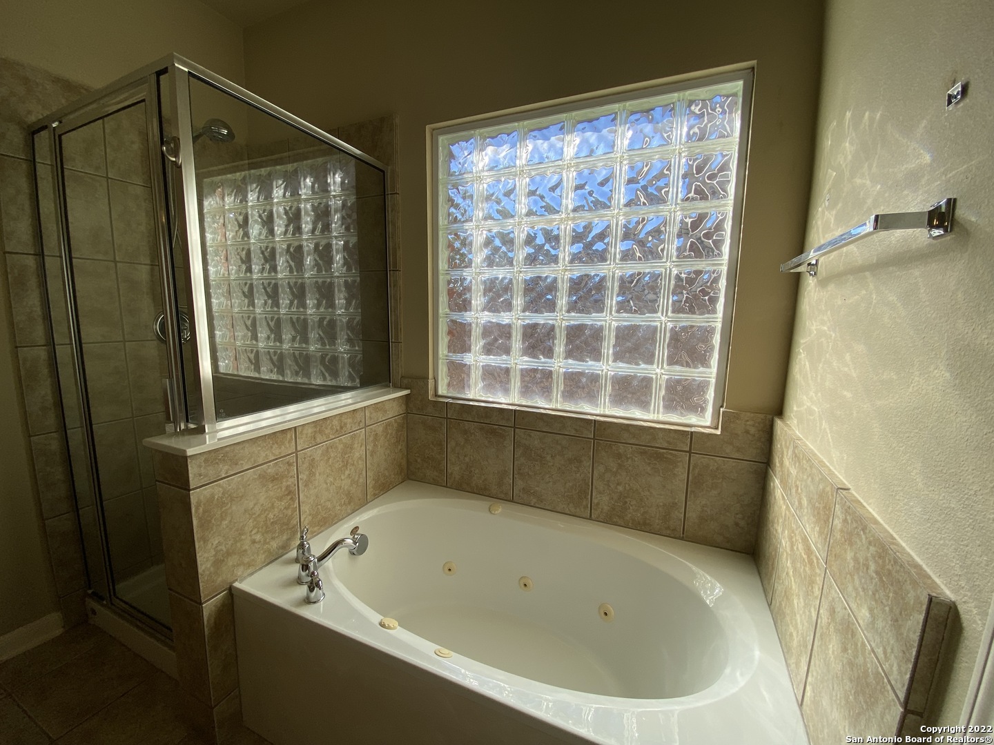 15518 Portales Pass Helotes, TX 78023 - Photo 15 of 25 a bathroom with a bathtub and a shower