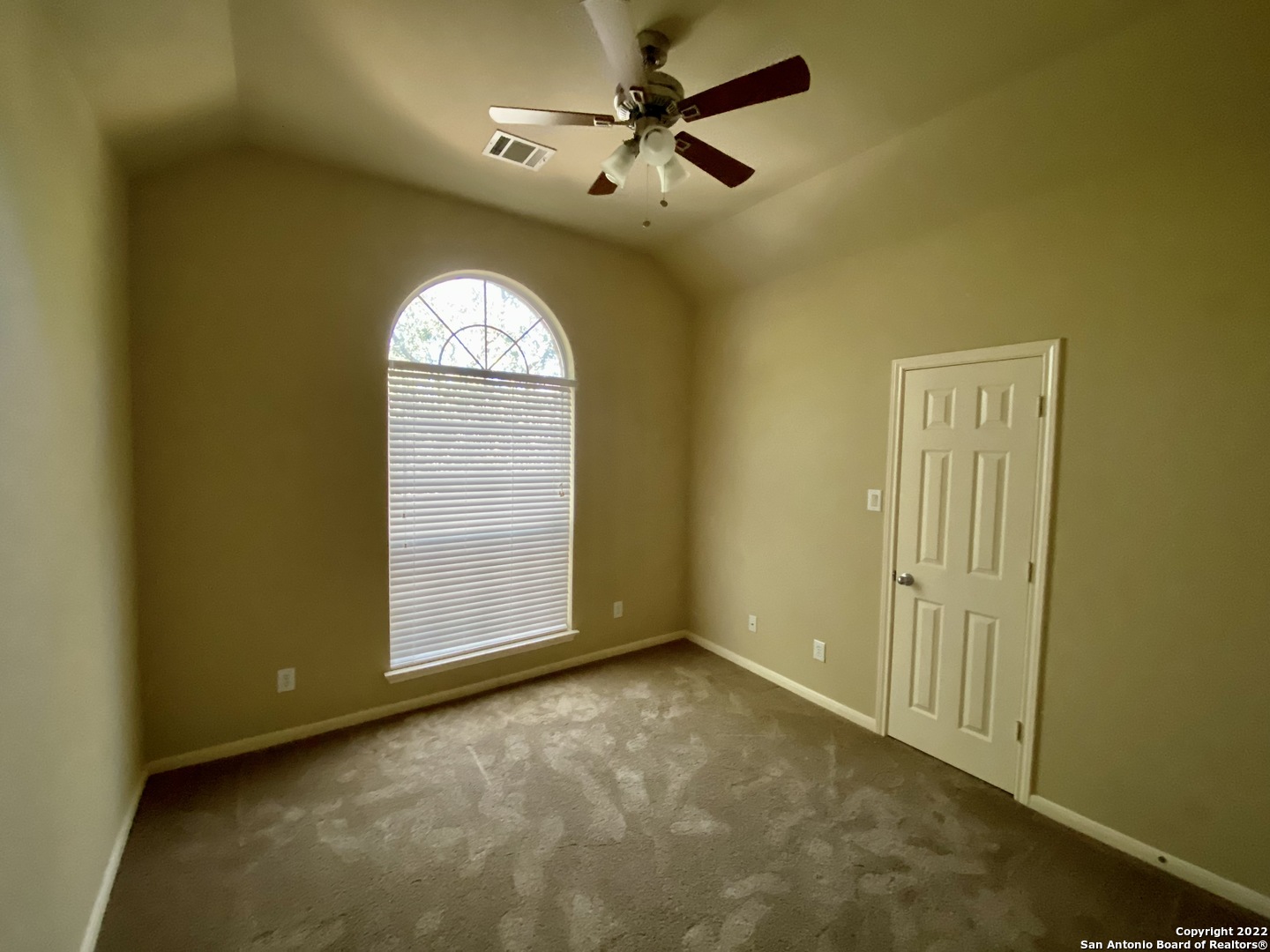 15518 Portales Pass Helotes, TX 78023 - Photo 18 of 25 an empty room with a ceiling fan and a window