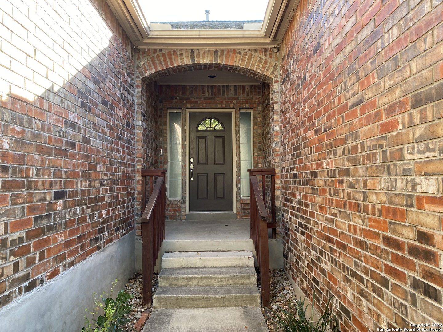 15518 Portales Pass Helotes, TX 78023 - Photo 2 of 25 a view of a brick house with a large window