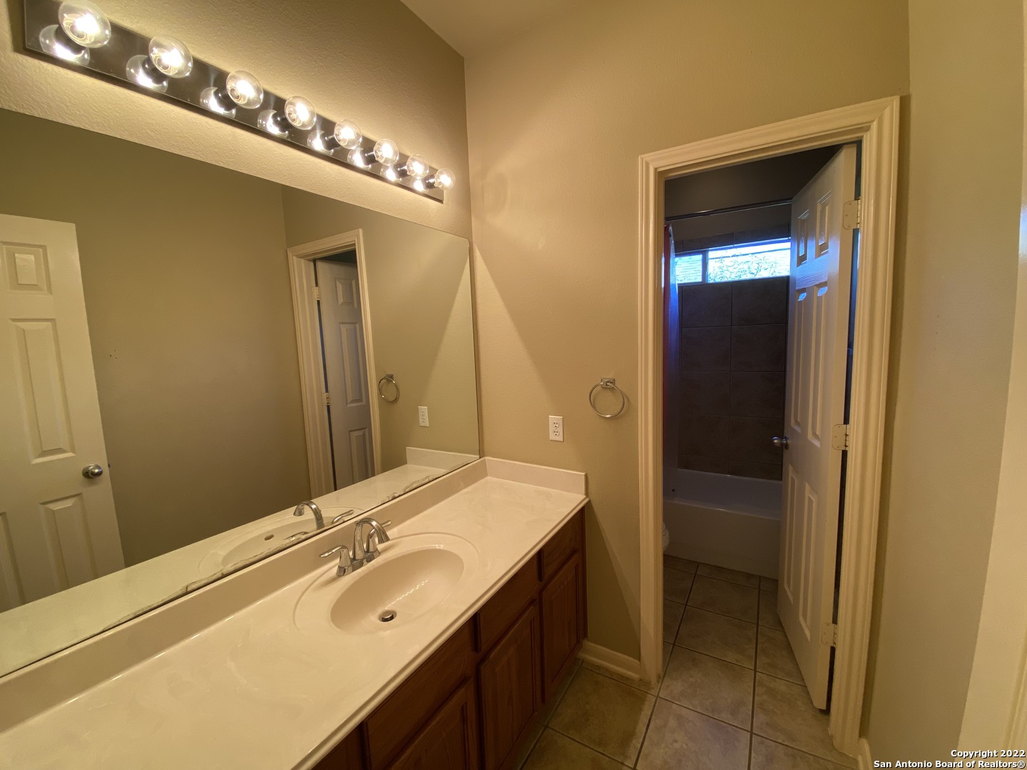 15518 Portales Pass Helotes, TX 78023 - Photo 21 of 25 a bathroom with a sink and a mirror